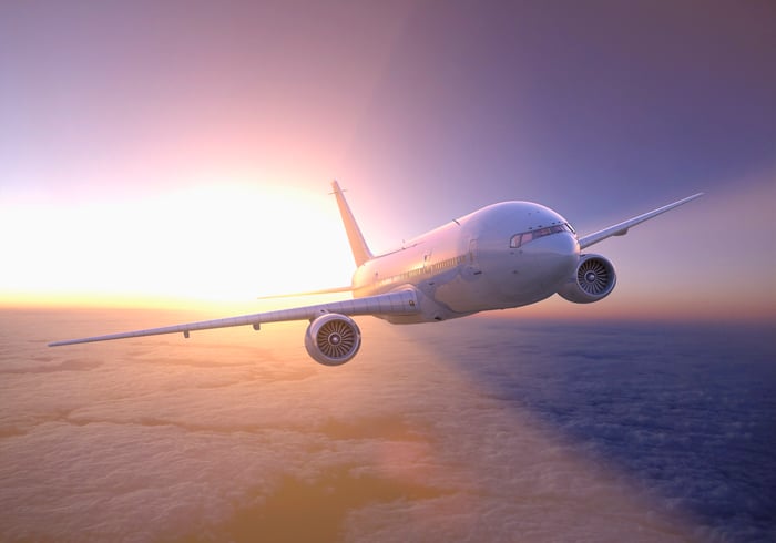 A plane soars above the clouds.