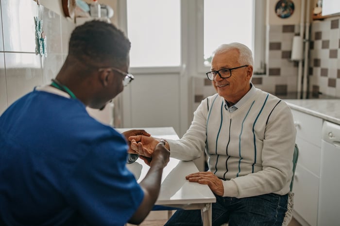 A medical professional working with an older adult patient.