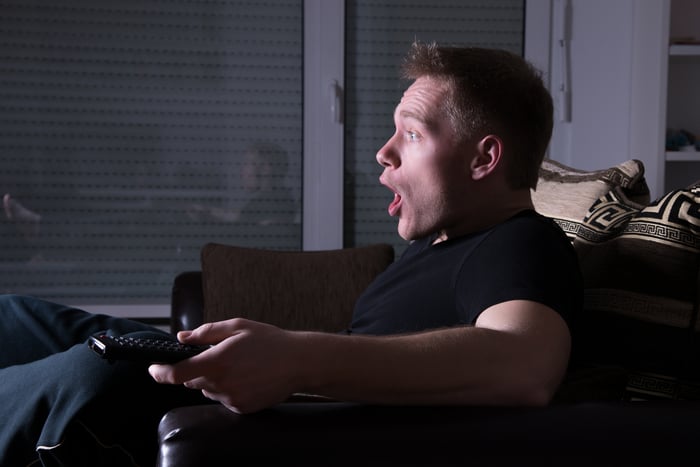 A TV viewer staring wide-eyed at the screen with their jaw dropped.