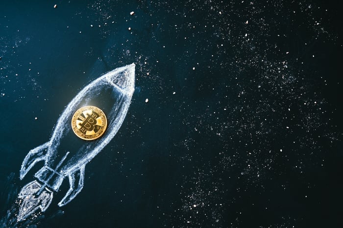 Bitcoin-themed rocket flying through space.