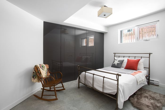 A bedroom in a basement apartment.