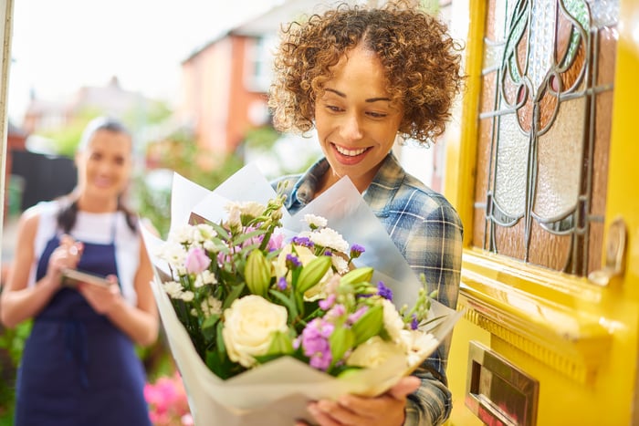 A person receiving a flower delivery.