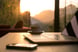 laptop computer coffee mug and phone sitting on desk with sunrise in background morning (1)