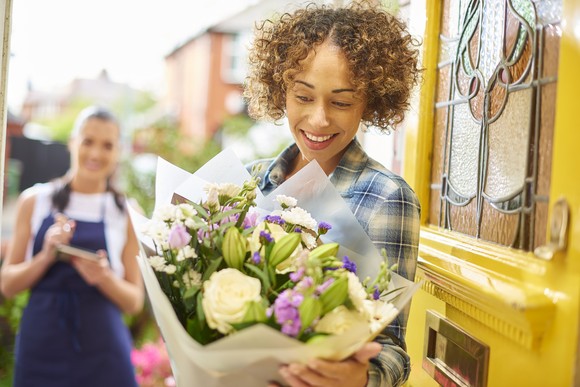 A person receiving a flower delivery.