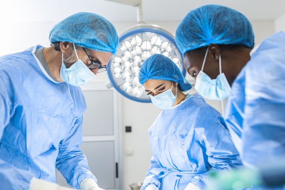 Three surgeons in an operating room.