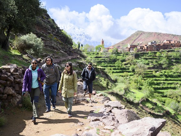 A group of people walking on an outdoor path.