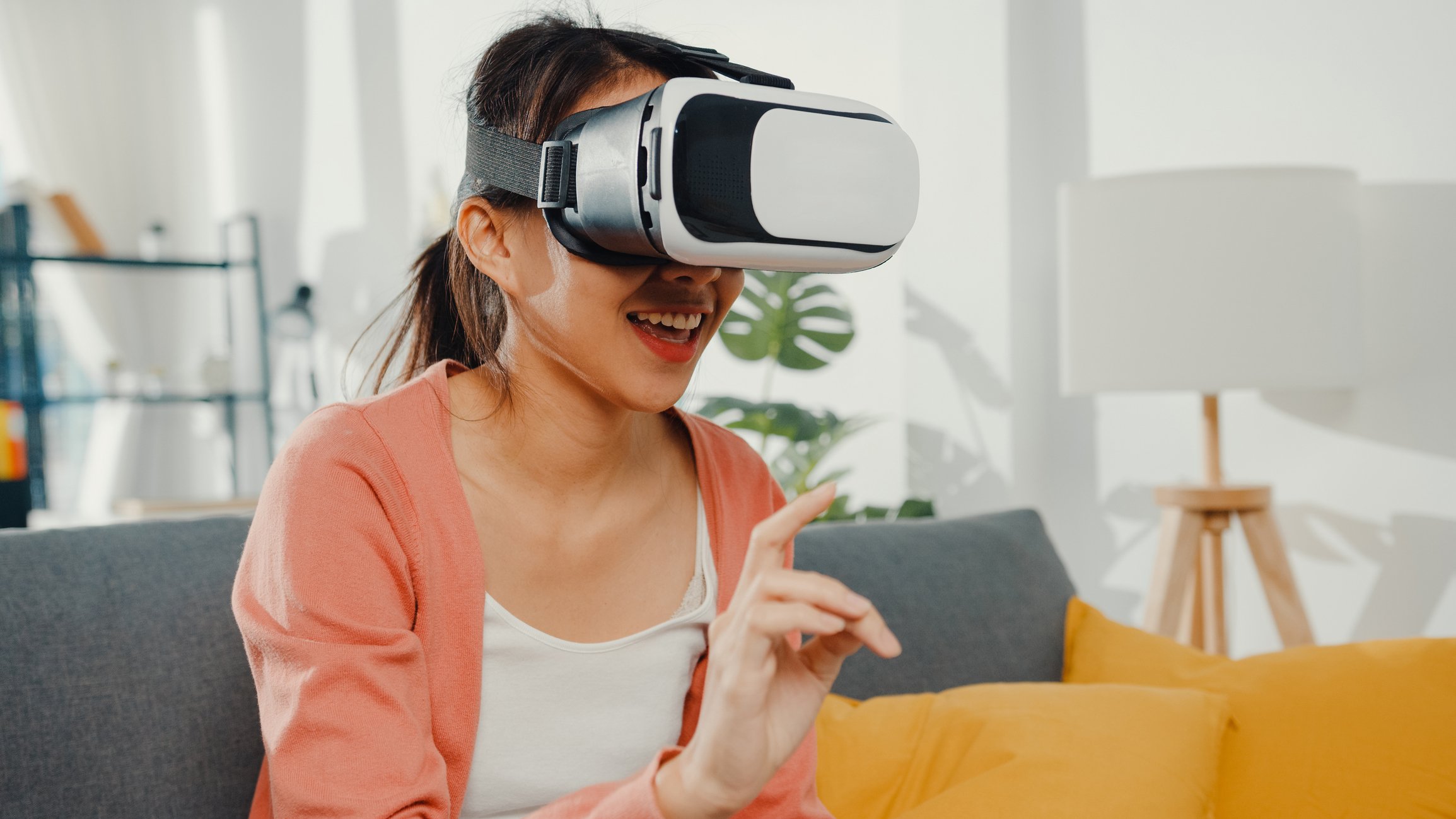 person sitting on couch wearing virtual reality headset