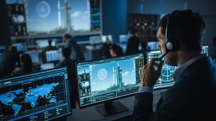 A flight director consults computers at mission control.