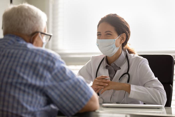 A doctor and patient speak to each other during an appointment.