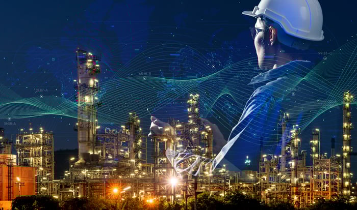 Computerized oil and gas setting against a dark blue background with a person in a hardhat superimposed.