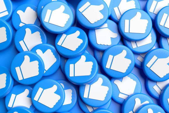 A pile of blue buttons with white thumbs-up icons.