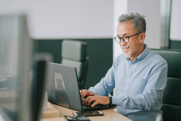 A person typing on a laptop.