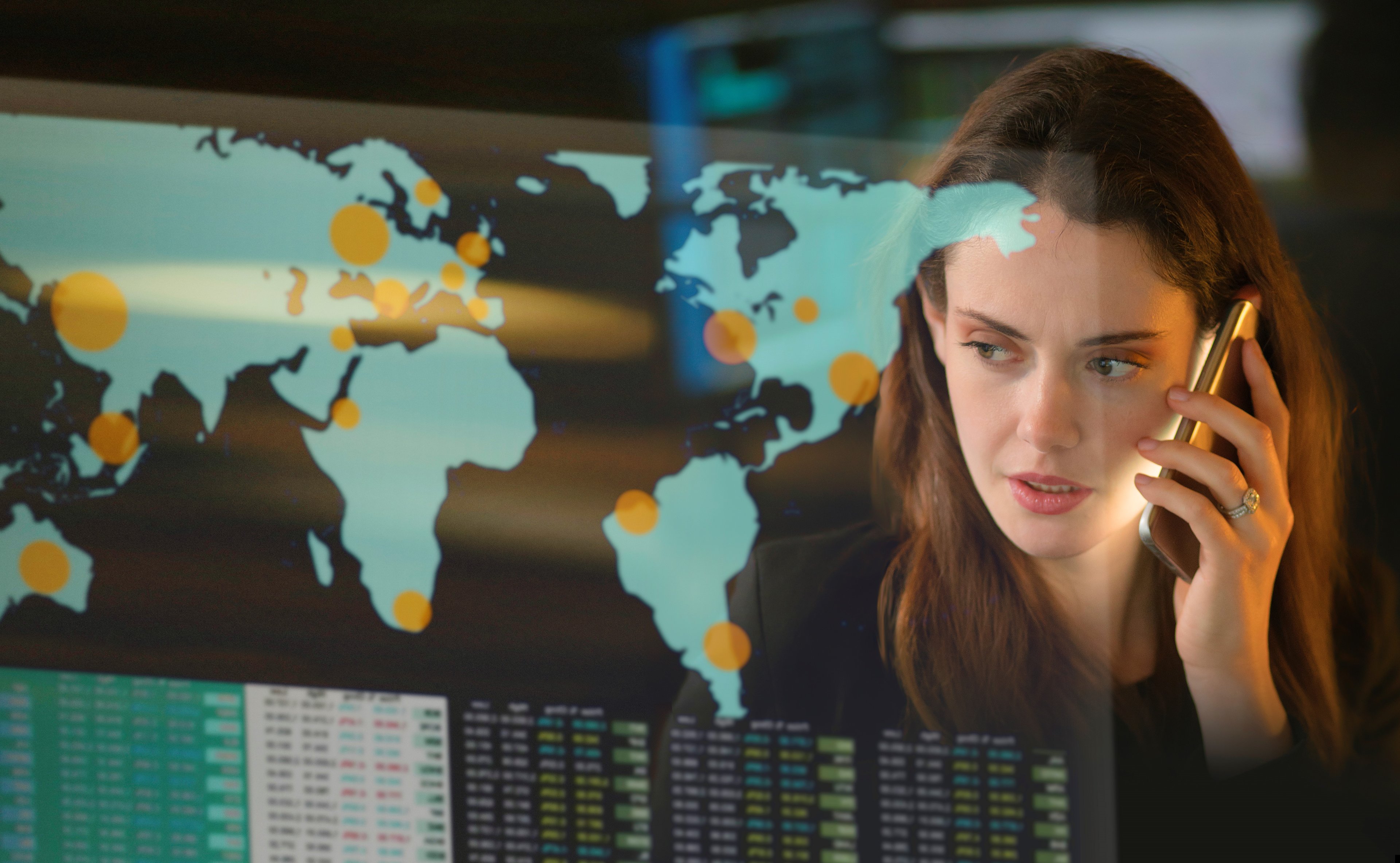 Person looking at a map of the world -- smaller -- GettyImages-1305132694