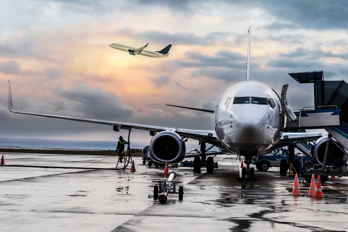 A plane awaiting departure at an airport.