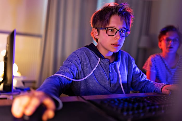 A young kid playing a video game on a computer.