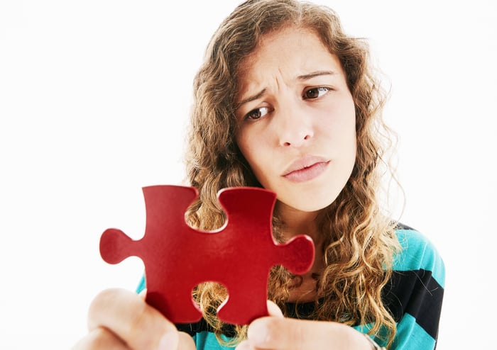 Person frowning at a big, red puzzle piece.
