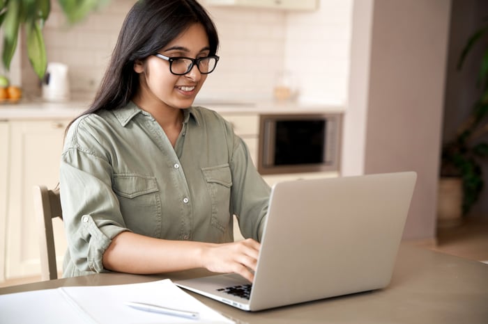 A person using a laptop computer.