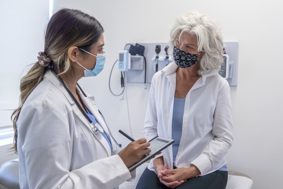 A patient and doctor talk to each other during an appointment.