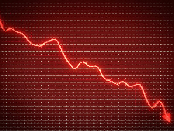 Glowing red arrow trending down on a stock chart.