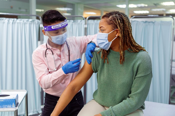 A healthcare worker gives a COVID-19 injection to a patient.