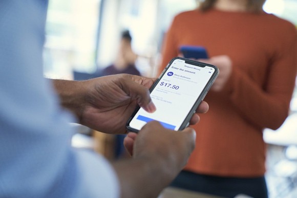 A person interacting with the U.S. Bank mobile app on their smartphone.