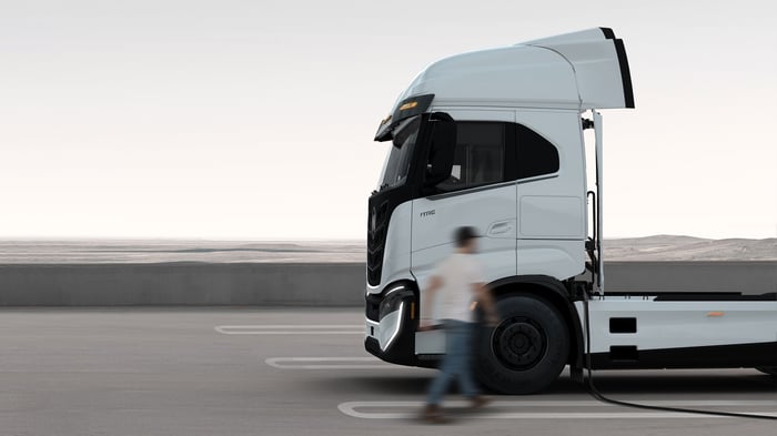 Nikola Tre BEV semi tractor plugged in for charging.