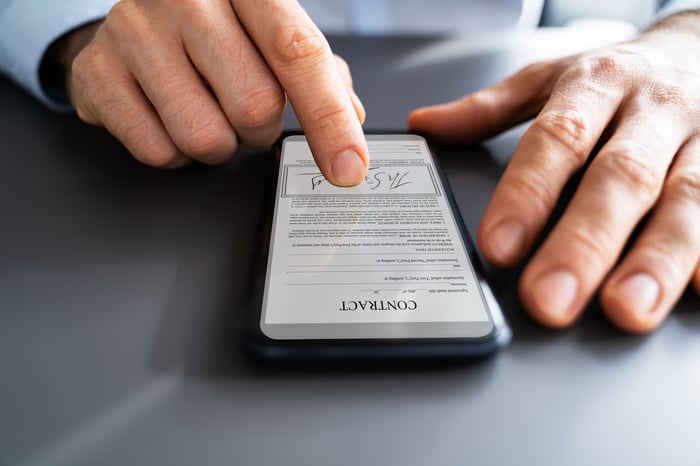 A person is using digital signature technology on a mobile phone.