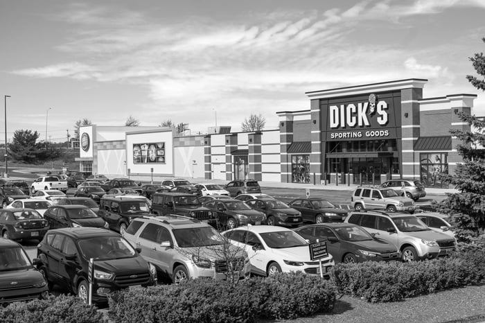 A black-and-white photo of cars in the parking lot at a Seritage shopping center.