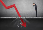 Investor watching a red arrow crash through the floor -- GettyImages-612737000