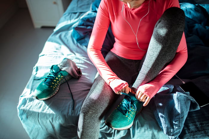 A person putting on athletic shoes.