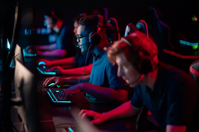 An esports team in action on their PCs.