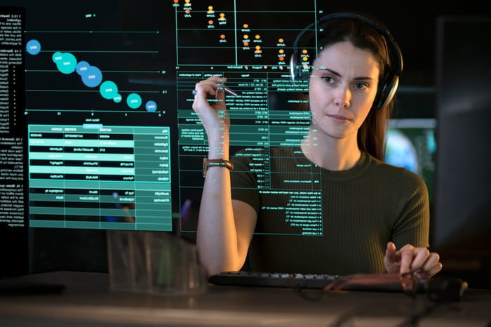 A person looking at data on a see-though computer display.