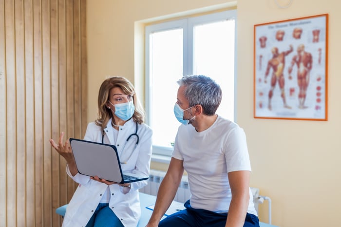 A patient talks to their doctor during an appointment.