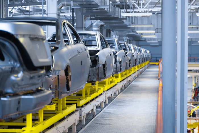 Vehicles lined up on a production line at a factory.