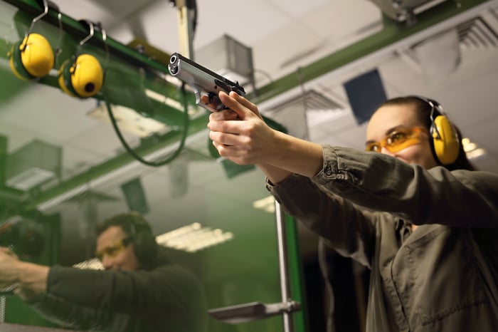 Person taking target practice at gun range.