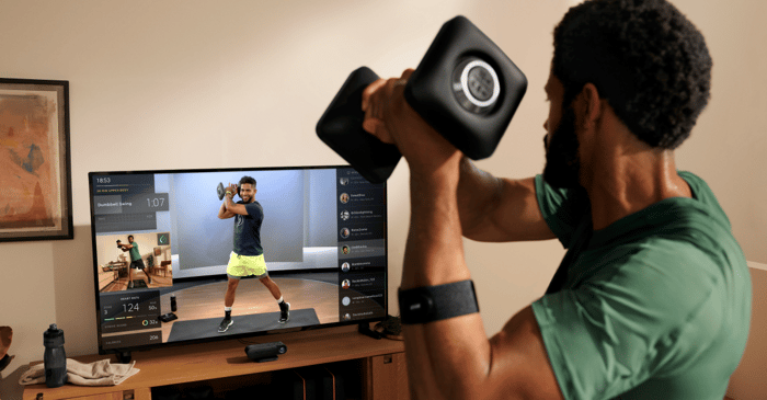 Person working out using Peloton Guide.