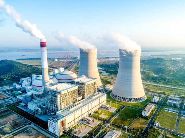 An aerial view of a running nuclear power plant station with two nuclear reactors.