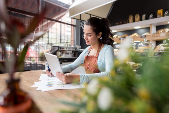 Someone in a cafe using a tablet.