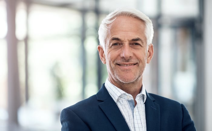 A closeup of a smiling professionally dressed person.