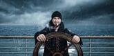 Captain sailing boat on rough seas -- GettyImages-1094631776