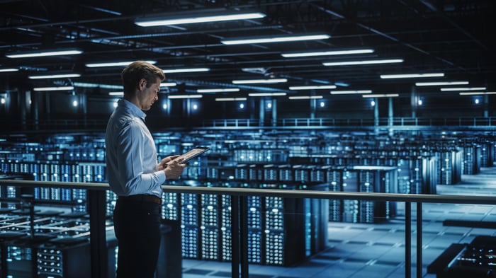 A person looking at a tablet in a data center.