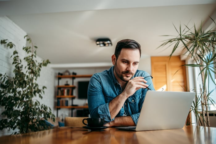 A person looking at a laptop screen.