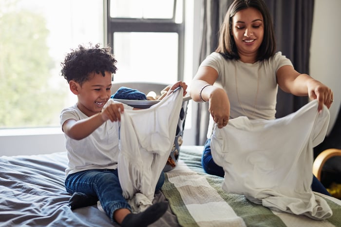 A mother and daughter doing laundry together.