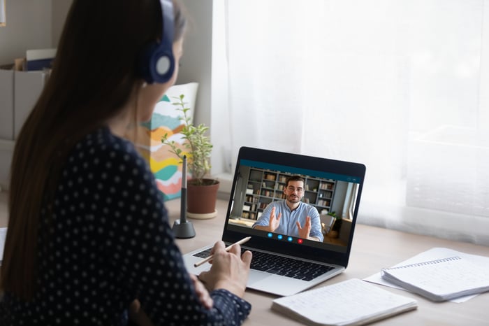A person on a video call while on their laptop.