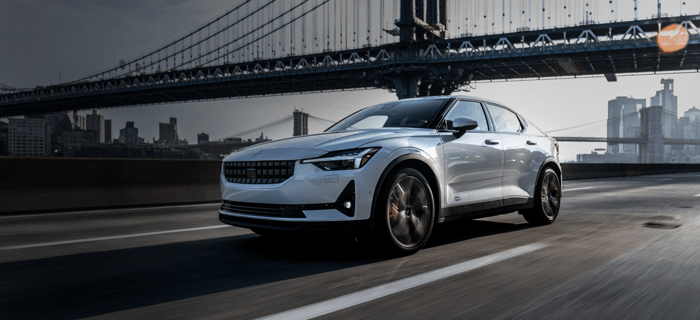 Polestar 2 driving on road under bridge.