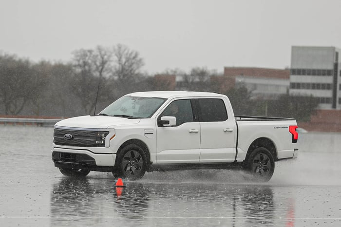 Ford F-150 Lightning electric pickup truck on a gray and rainy day.