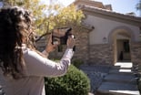person taking picture of house