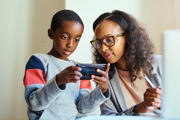 A mother and her son using a smartphone.