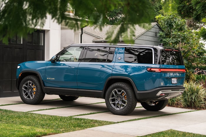 A Rivian electric vehicle parked in the driveway of a home.