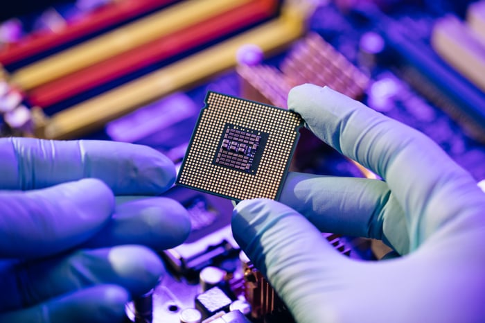 A lab worker holding a CPU.